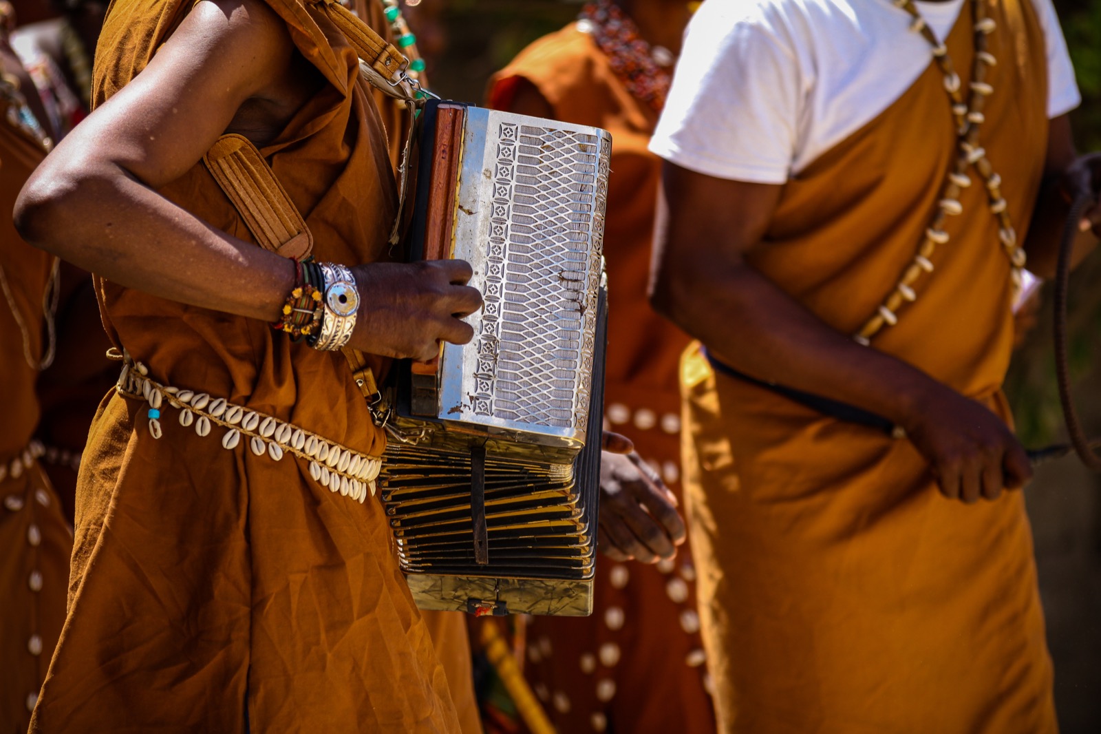 Adults wearing traditional clothing with music